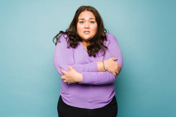 istock Cold fat woman shivering feeling chilly 1455591424