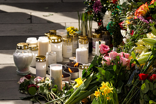 flowers and candles on street after terror