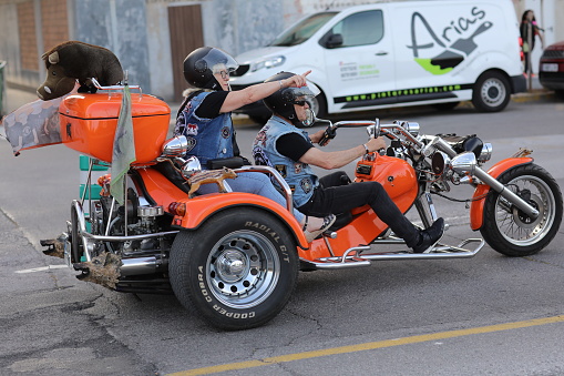 CASTELLON, SPAIN - MAY 21: Unidentified senior participants of the biker festival on a powerful three-wheeled motorcycle.