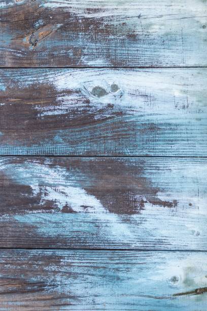 istock Aged wooden planks background with white and blue peeling paint 1455591725