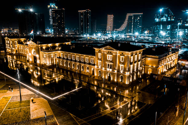 Impressive scenery with famous old train station and tall buildings in the background of the new part of Belgrade captured during the night with a drone.