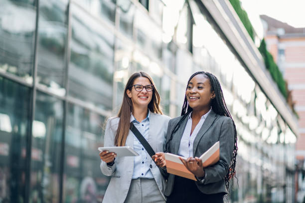 istock Two multiracial business woman meeting outside and using a tablet 1455593740