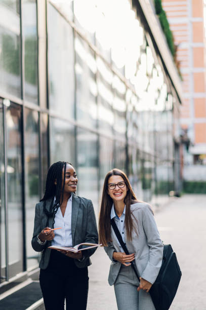 istock Multiracial business woman meeting outside and using a tablet 1455593745