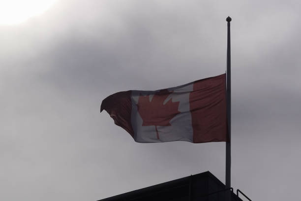 istock canadian flag at half mast against sky 1455596502