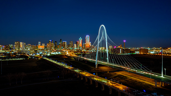 The big city and the bridge at the entrance to the city of Dallas at night with its lights on the buildings