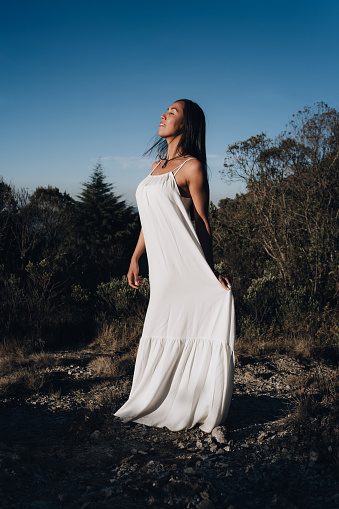 Woman in white dress in nature park