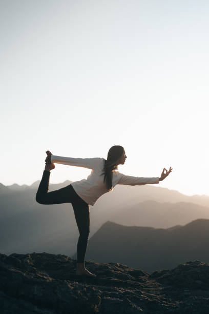 istock Woman practicing yoga in the mountains 1455601078