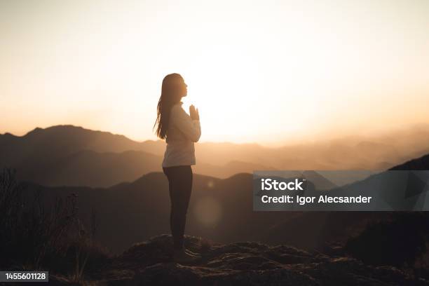 Woman Meditating At Sunset In The Mountains Stock Photo - Download Image Now - Meditating, Zen-like, Gratitude
