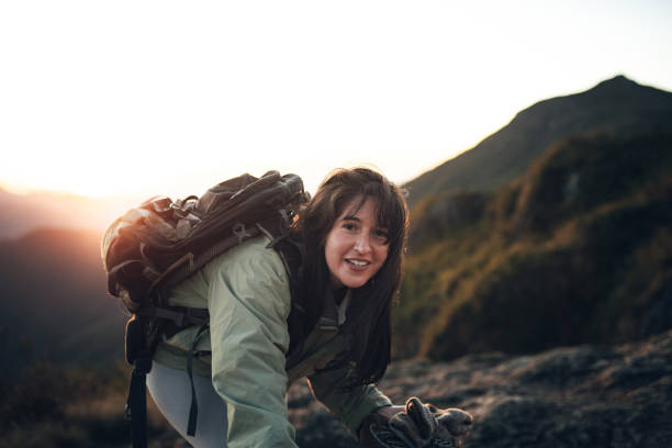 istock Backpacker climbing the mountain at dawn 1455601779