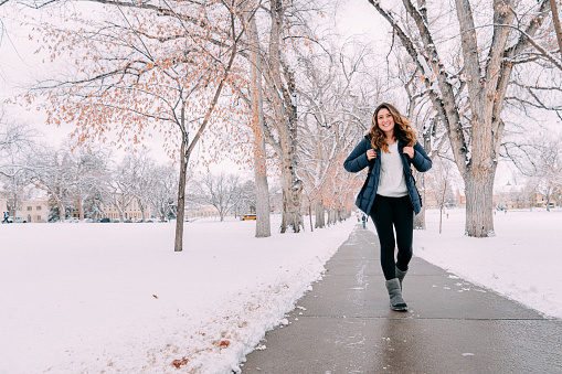 Cute Portrait of a Cheerful University Student Standing on Campus on a Snowy Day in Colorado at CSU / Colorado State University Oval Park
