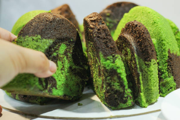 woman hand take marble cake.marmer cake jadul. pandan black cticky rice butter cake. old traditional receipe. selective focus. delicious. - marmer imagens e fotografias de stock