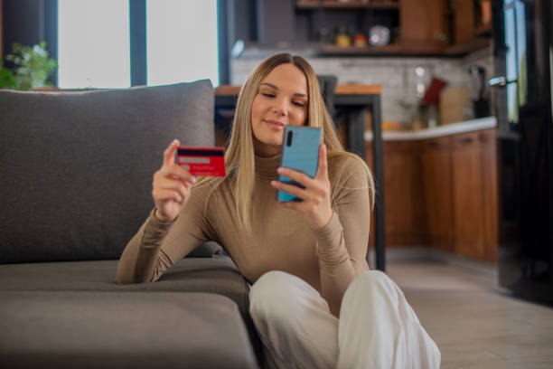 istock Cheerful  young woman doing online shopping 1455604921