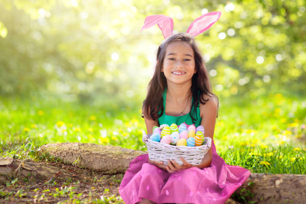 Little girl with Easter bunny. Egg hunt.