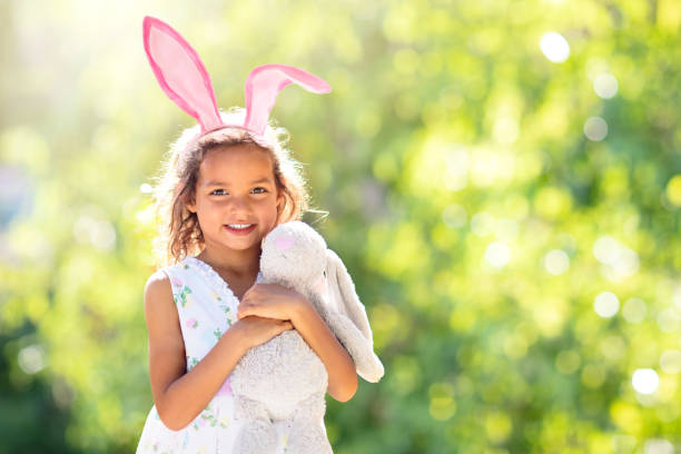 istock Little girl with Easter bunny. Egg hunt. 1455607369