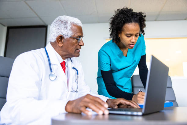 istock Black doctor and nurse consulting on a patient file 1455609731