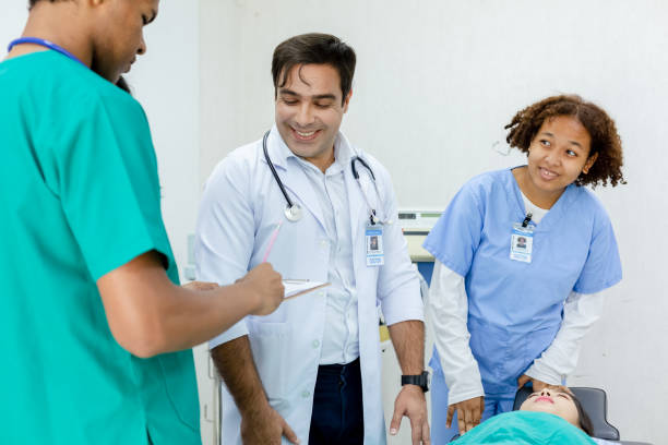 istock Professional medical teacher give tuition group students in patient operating room. studying classroom university. 1455609781