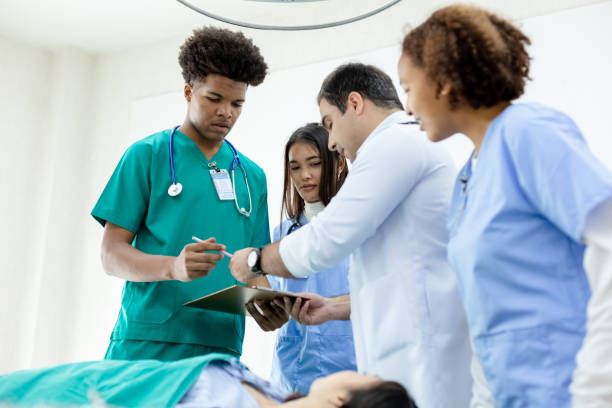 istock professional medical teacher give tuition group students in patient operating room. 1455609792