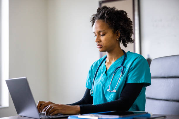 istock Medical student on laptop in classroom 1455609916