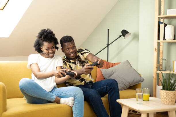 istock African American couple having fun gaming at home 1455610132