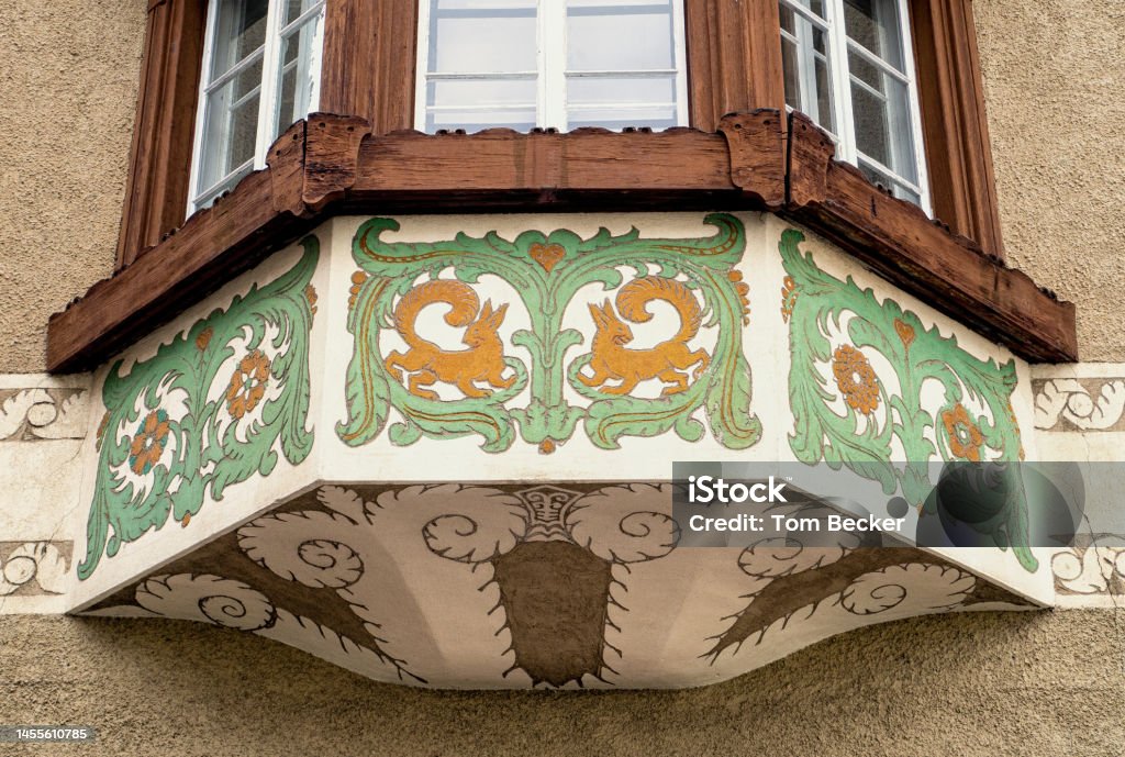 Decorative architecture and design on residential building in Samedan Switzerland Architecture and design adds life and color to buildings in Engadine area of Switzerland Architectural Feature Stock Photo