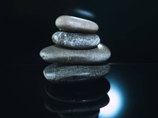 istock Pile of pebbles on a dark glowing surface 1455615907