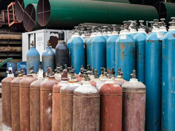 Selective focus image with noise effect cylinder tanks with compressed gas for industry use.