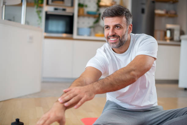 istock Man at home keeping fit by exercising 1455618295