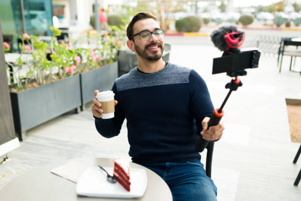 istock Happy content creator filming a video at the coffee shop 1455624951