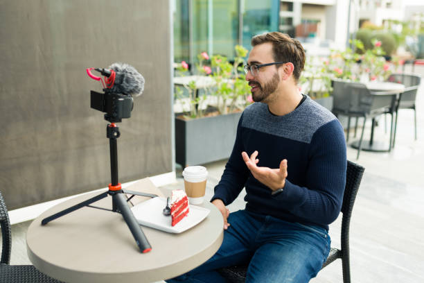 istock Caucasian content creator filming a social media video with a camera 1455624982