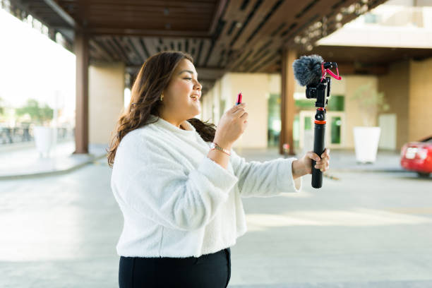 istock Cheerful influencer doing makeup reviews online 1455626153