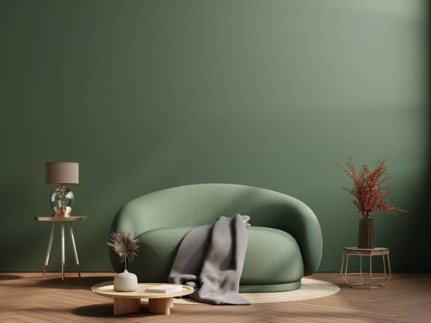 istock Wall mockup in dark tones with green sofa on green wall background. 1455629235