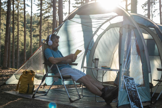 istock Couple camping in nature at sunset. 1455629647