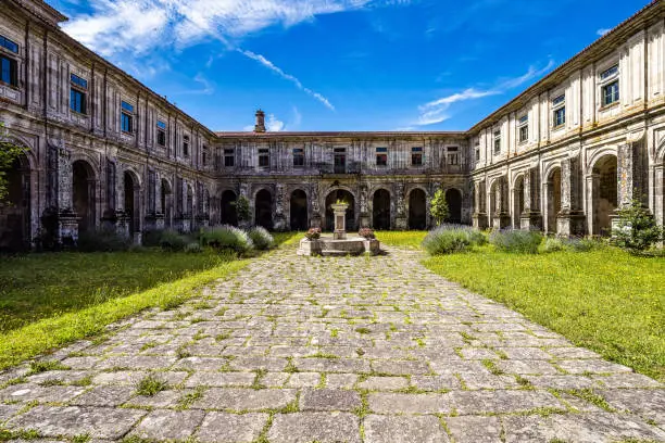Courtyard of the monastery of Oseira at Ourense, Galicia, Spain. Monasterio de Santa Maria la Real de Oseira. Trappist monastery. Arched buildings and fountain.