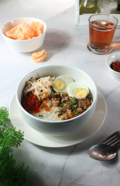 istock rice porridge with boiled egg and shredded chicken topping 1455640720