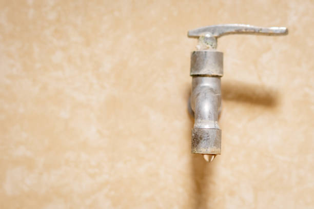 istock A faucet with a water drop. Water consumption concept. 1455642140
