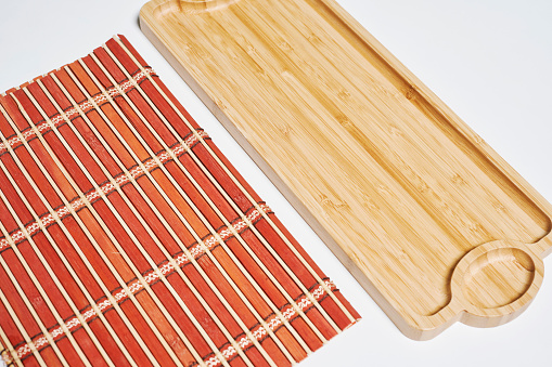 A close-up shot of bamboo mat and wooden board
