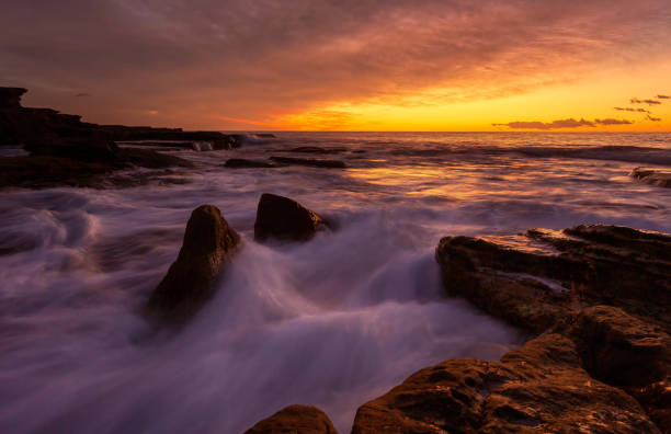 istock Ocean waves surging over rocky coast with incoming tide 1455648949