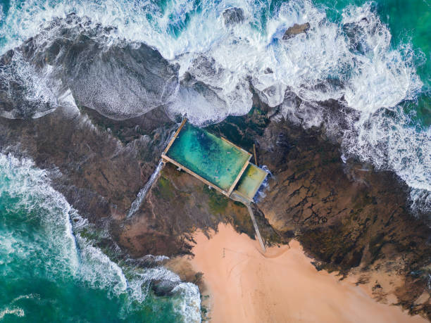 istock Tidal swimming pool built on a rock shelf surrounded by ocean 1455648950