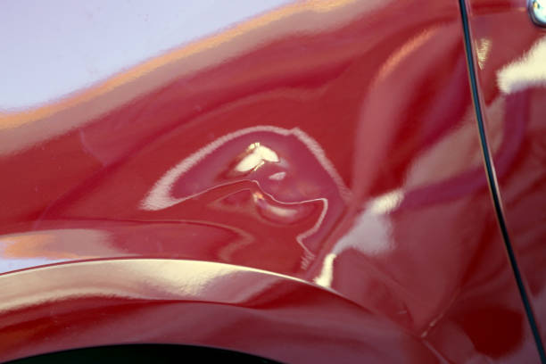 A close-up abstract photograph of a classic red sportscar