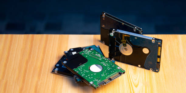 istock Close-up side view of hard disk on wooden floor 1455654188