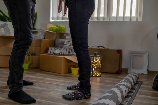 Closeup Shot Of Black Spouses Hugging Among Cardboard Boxes In New Flat Home improvement, do it yourself activity in new home diy table legs stock pictures, royalty-free photos & images