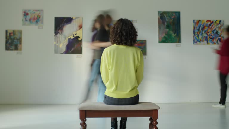 Timelapse of Woman Sitting in Art Gallery