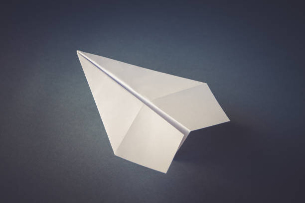 istock White paper plane origami isolated on a grey background 1455656819