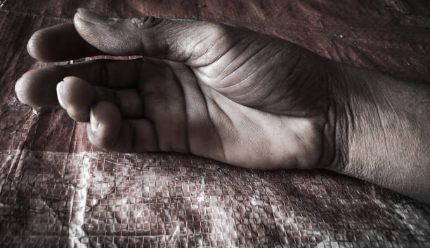 istock Dead hand on a red background  background design template violence war loss desperate 1455656921