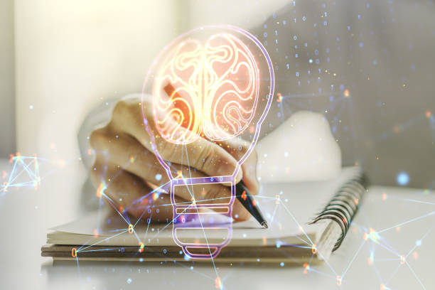 istock Creative idea concept with light bulb and human brain illustration with man hand writing in notebook on background. Neural networks and machine learning concept. Multiexposure 1455657902