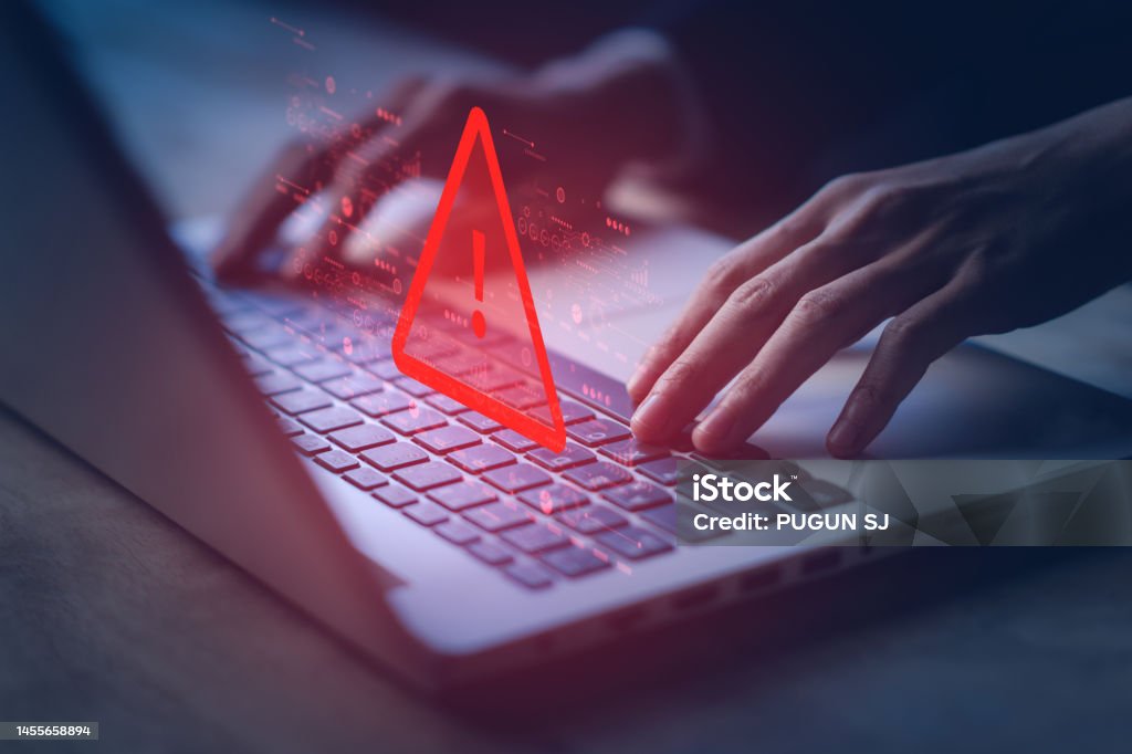 System hacked warning alert on notebook (Laptop). Cyber attack on computer network, Virus, Spyware, Malware or Malicious software. Cyber security and cybercrime. Compromised information internet. Computer Crime Stock Photo