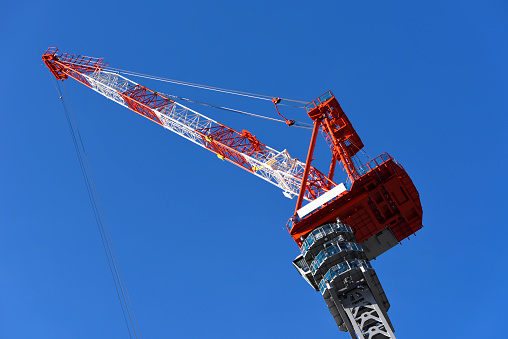 Construction site crane against clear sky with copy space.