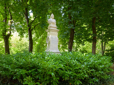 Bruges, Belgium-July 3, 2022: Statue of Henrick Pickery in a park in Bruges, nature, green