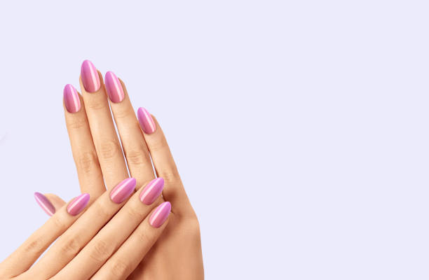 istock Female hands with beautiful pink manicure on white background 1455660816