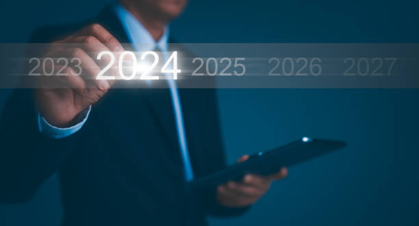 istock Happy new year 2024 hand touch on a virtual screen 2024. New Goals, Plans, and numbers for Next Year. Businessman touching future growth year 2023 to 2024. Planning, opportunity, business strategy. 1455660921